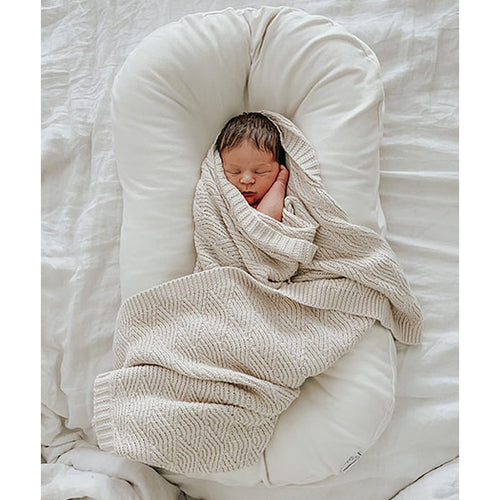 Baby swaddled in Organic Shell Stitch Blanket