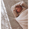 Infant resting in the Bundl Wool Baby Wrap