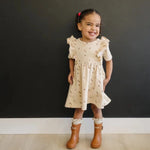Toddler wearing Floral Ruffle Dress and smiling