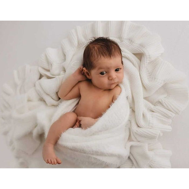 Baby swaddled in Organic Milk Frill Blanket