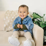 Child smiling and wearing the Infant & Toddler Jean Jacket 