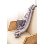 Organic Frill Blanket Lilac Speckle laid over a chair