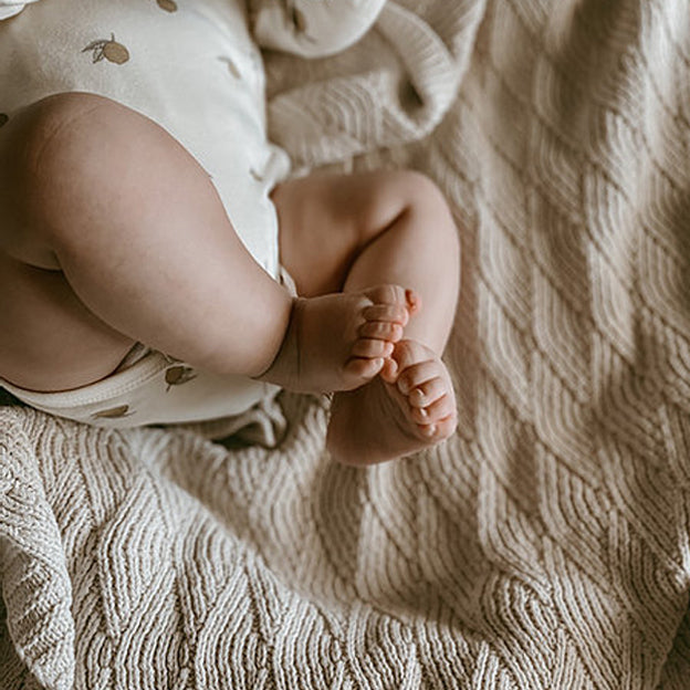 Infant’s feet on Organic Shell Stitch Blanket